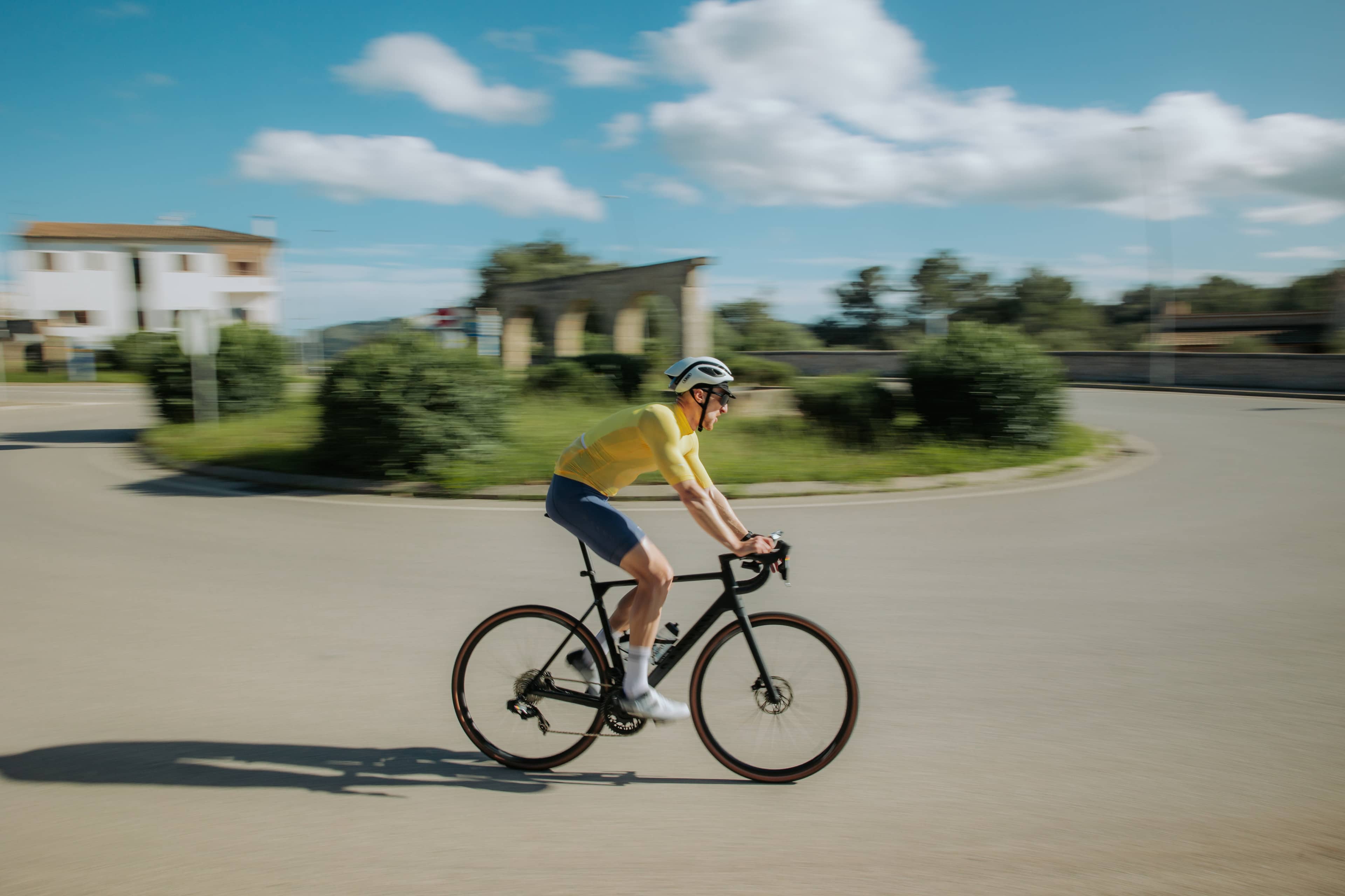 Kevin cycling in yellow jersey with motion blur
